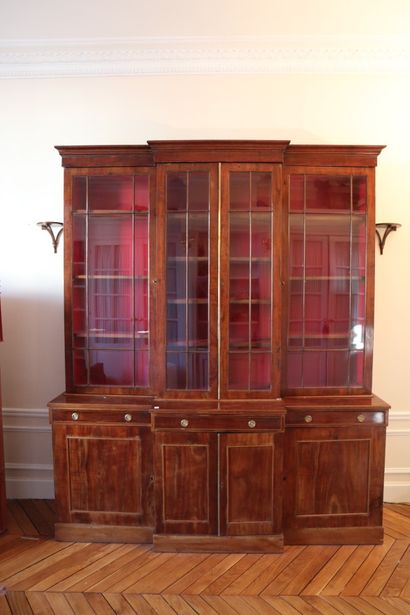null A mahogany veneer overhanging showcase opening with three glass doors in the...