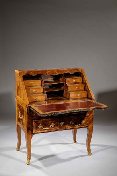 null Slope desk in walnut. A flap uncovering six small tiered drawers and niches,...