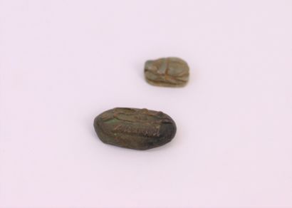 null Egypt. 

A beetle engraved with hieroglyphics and a token with fish decoration....