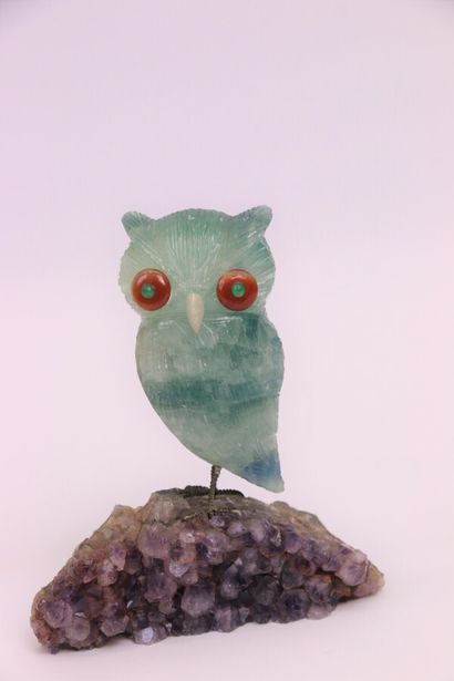 null 
Two fluorite animals representing an owl resting on an amethyst crystal and...