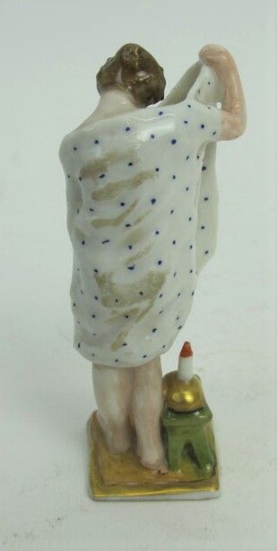 null Two polychrome porcelain subjects representing a woman admiring her intimacy...