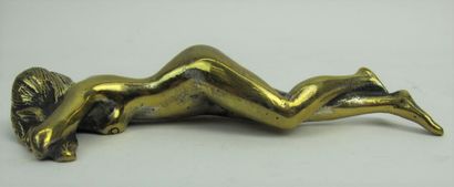 null Gilt bronze paperweight representing a woman in a state of relaxation.

L ....