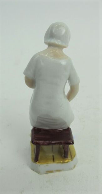null Two polychrome porcelain subjects representing a woman admiring her intimacy...