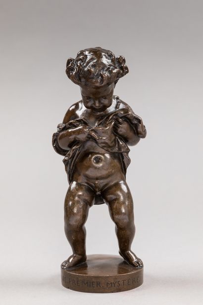 null A chased bronze subject with a brown patina representing a young boy discovering...