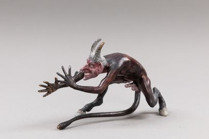 null Chased and polychromed bronze subject representing a devil making a nose foot,...