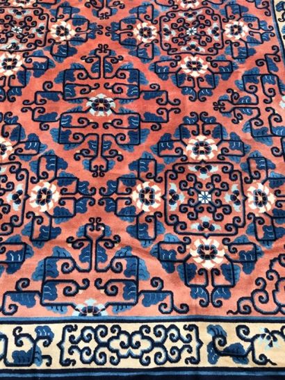  CHINE 
Tapis en laine à décor polychrome de motifs géométriques, bordure bleu marine....