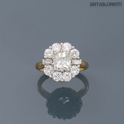 null A yellow and white gold daisy ring centered on a cushion-shaped old cut diamond...