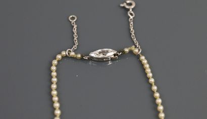 null Necklace made of two cultured pearls and one hundred and ten creamy white rounded...