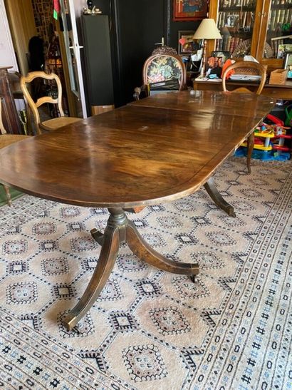 null Oval table in natural wood, two tripod legs ending in casters. 

An extension...