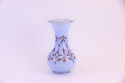 null A blue opaline vase with a flared neck decorated with lambrequins and gold fillet....