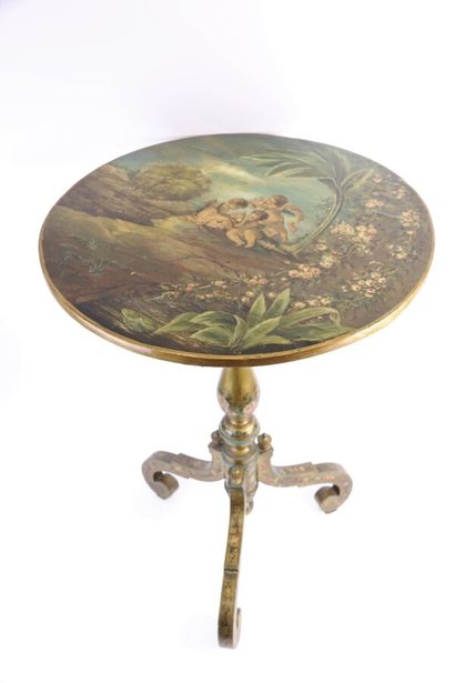 null A painted and gilded wood tripod pedestal table, the top decorated with three...