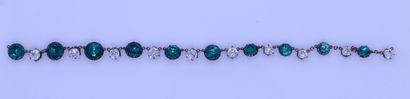 null Metal bracelet decorated with stones in imitation of diamond and emerald.

L....