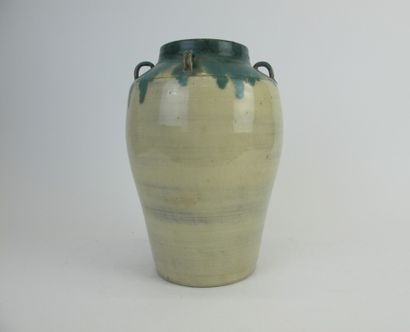 null A cream enamelled terracotta vase with green drips and four small handles. 

H....