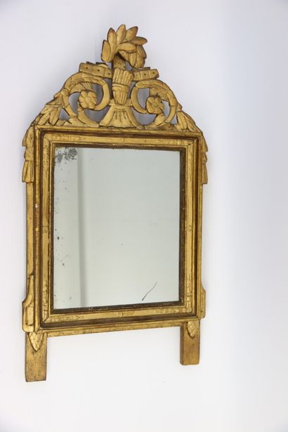 null A carved and gilded wood mirror frame, with scrolls, flowers and laurel garlands...