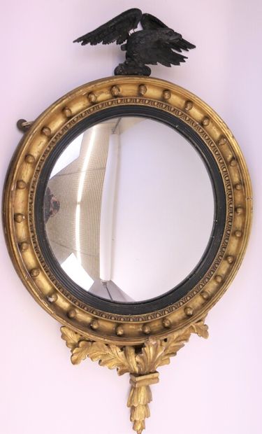 null Round convex mirror, gilded wood frame carved with water leaves and pearls,...