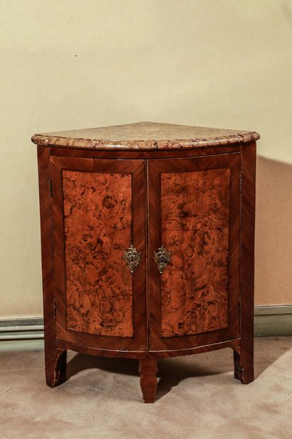 null A rosewood and walnut veneered cove, opening on two doors, with a marble top,...