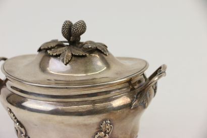 null A silver covered sugar bowl of oval shape standing on four scrolled feet with...