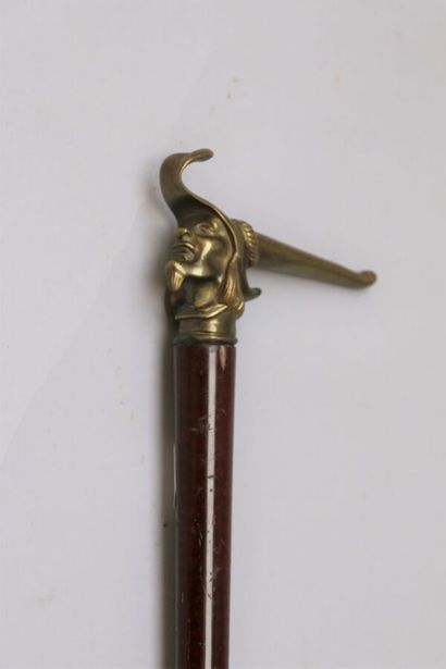 null Cane-massue with a weighted "bicorne" knob, the shaft in flamed exotic wood,...