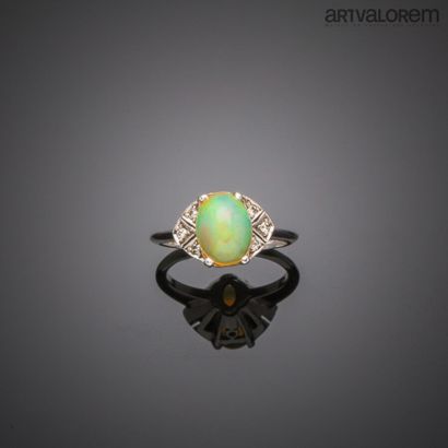 null Ring in white gold 750°/°° centered of an opal cabochon in claw setting resting...