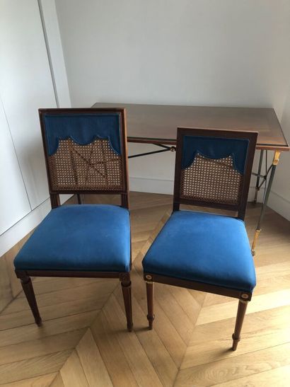 null Two wooden chairs, partially caned back, standing on a tapered and fluted base,...