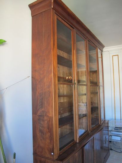 null Mahogany and mahogany veneer bookcase opening with four glass doors in the upper...