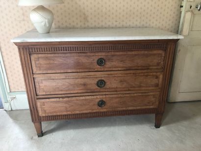 null Natural wood chest of drawers with fluting and framing, white marble top.

Louis...