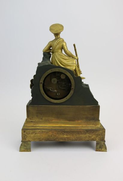 null A chased bronze clock with a green patina, showing a Scottish hunter holding...