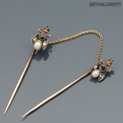 Pair of yellow gold and silver tie pins linked...