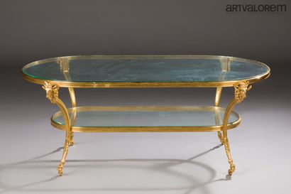 Gilded brass coffee table with two oval-shaped...
