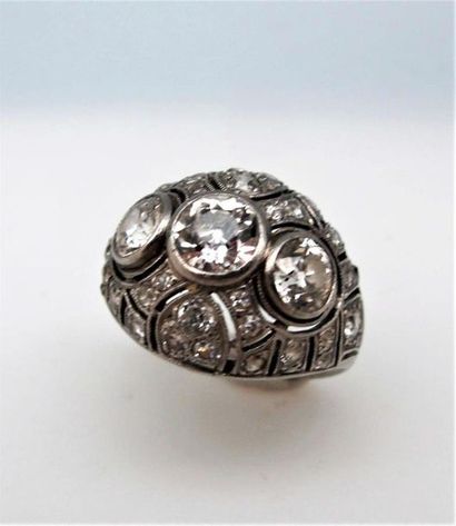 null Platinum dome ring adorned with three old-cut diamonds in a closed set in a...
