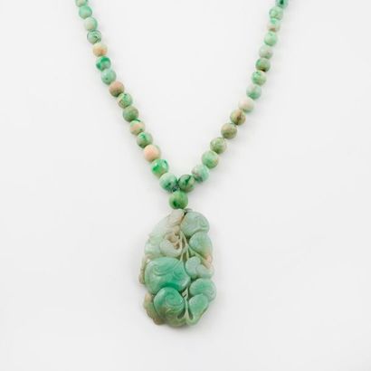 CHINE, XXème siècle 

Sautoir en perles de jadéite vert pâle en chute, centré d'un...