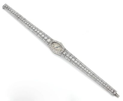 null Montre bracelet de dame en or gris (750).
Boîtier ovale inscrit dans le bracelet...