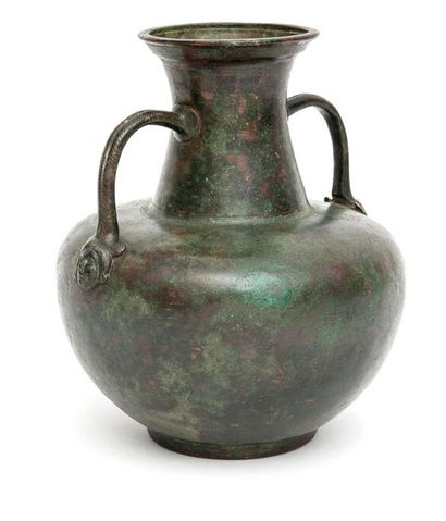 null Jug with two bifid handles whose bases are adorned with female
bronze masks...