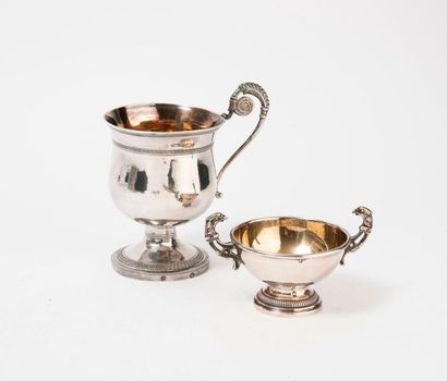 null 
Small cup on a gadrooned silver (800) white and gold pedestal with two handles...
