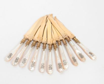 null 
Eleven fruit knives, with blade and ferrule with a silver-gilt (950) foliated...