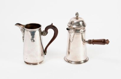 null 
Two shaped pieces in silver (950):

- A pitcher with a fluted spout and laurel...