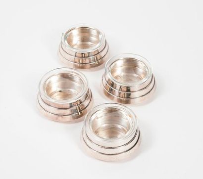RAVINET DENFERT 

A suite of four circular silver-plated metal saltcellars with stylised...