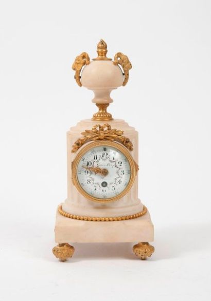 null White marble terminal clock forming a fluted half-column topped by a fire pot...