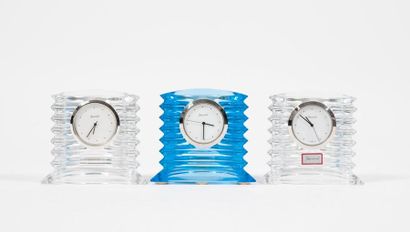 BACCARAT 

Three Lalande clocks.

In colourless (x2) or blue-tinted crystal. 

H....