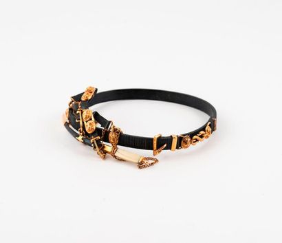 null Black steel bracelet grooved in the shape of a miniature belt with gold metal...