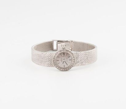 OMEGA DE VILLE Montre bracelet de dame en or gris (750).
Boîtier rond. 
Lunette ornée...