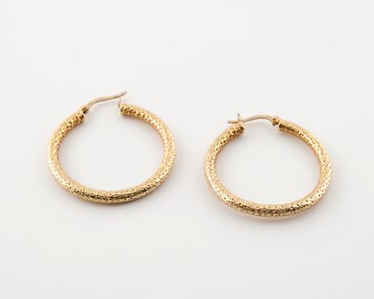 Pair of hollow, textured yellow gold (750)...