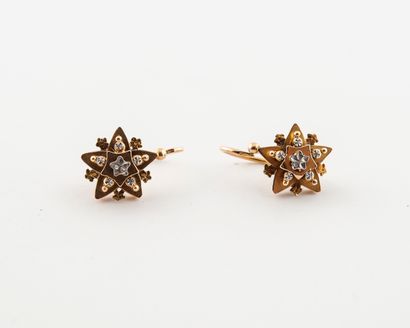 null Pair of yellow and white gold sleepers (750) with star pattern. 

System for...