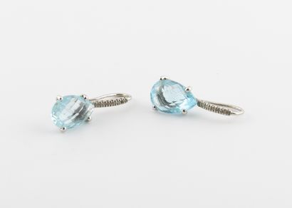  A pair of white gold (750) earrings set with faceted drop-shaped blue topazes, with...