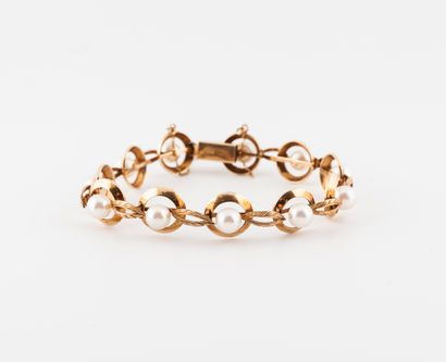 null Articulated bracelet in yellow gold (585) with round openwork links, centered...