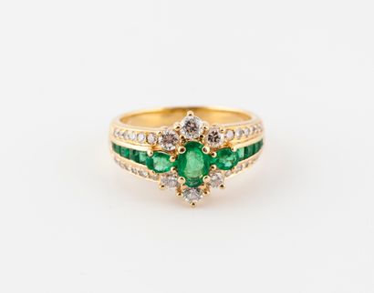  A yellow gold (750) ring centered on a flower motif set with faceted oval and drop...