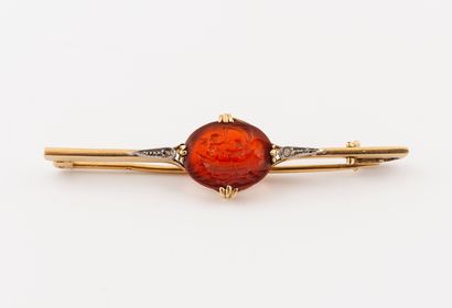 null A yellow gold (750) barrette brooch centered on an oval cornelian intaglio showing...