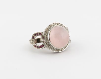 null A white gold (750) ring, centered on a cabochon of pink quartz in a closed setting,...
