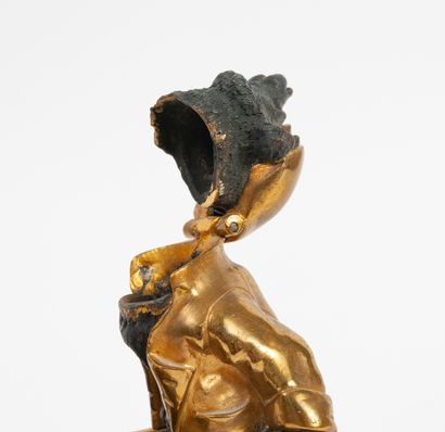 null 
A gilded and patinated bronze inkwell in the guise of a bear pushing a wheelbarrow,...