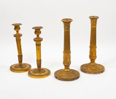null 
Two pairs of torches:




- One in gilt brass, the foot with palmettes arranged...